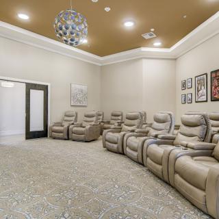 A luxurious home theater featuring comfortable recliners and modern decor.