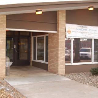 Entrance to a brick commercial building with a banner above the doorway.
