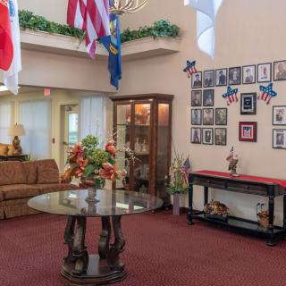 A welcoming lobby with flags, a sofa area, and decorative elements.