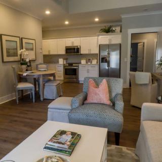 A modern open-plan living room and kitchen area with stylish decor and cozy furnishings.