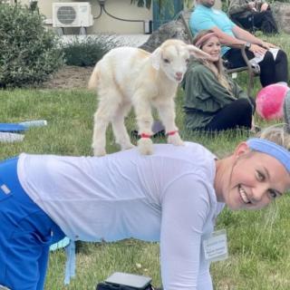 A joyful moment during a goat yoga session.