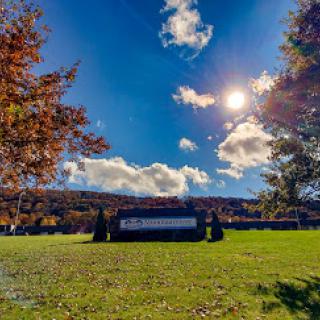 A beautiful autumn day featuring vibrant foliage and a bright blue sky.