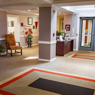 A well-decorated lobby with a reception desk and seating area.