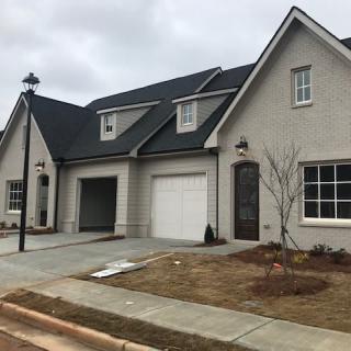 A modern suburban house with a spacious driveway and attached garage.