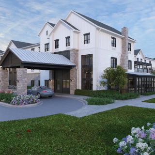 A modern residential house with a landscaped garden and driveway.