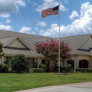 A suburban house with an American flag on a sunny day.