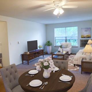 A stylish and inviting living space featuring a cozy dining area and comfortable seating.