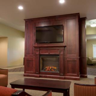 A warm and inviting living room featuring a modern fireplace and a mounted television.