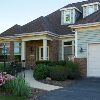 A suburban house with a well-maintained garden and attached garage.