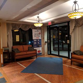 A cozy hotel lobby featuring comfortable seating and warm lighting.