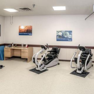 An indoor exercise room with fitness equipment and workout machines.