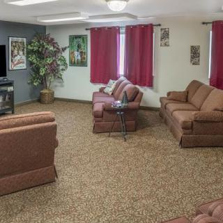 A cozy living room with comfortable sofas and a TV.
