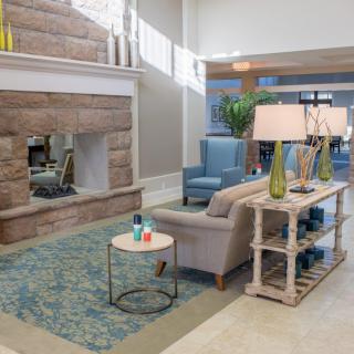A modern living room with elegant furnishings and a cozy fireplace.