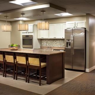 A modern kitchen with a large island and stainless steel appliances.