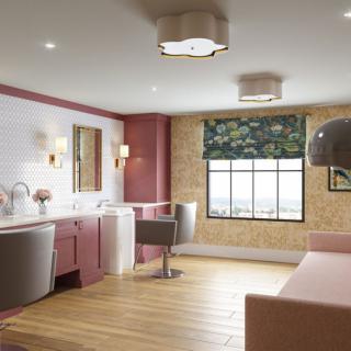 A modern salon interior featuring stylish furniture, contemporary lighting, and a large window with decorative shades.