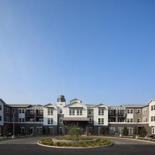 Modern residential building with a clear blue sky backdrop.