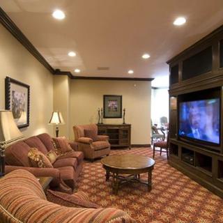 A cozy living room with comfortable seating and a large television.