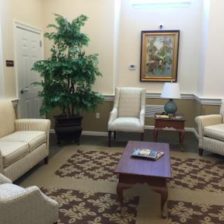 A cozy waiting area featuring comfortable seating and decorative elements.