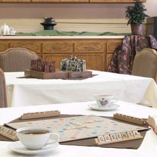 A cozy indoor setting featuring a Scrabble board game on a table alongside a teacup.