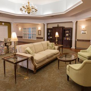 A cozy living room with elegant furniture and a chandelier.