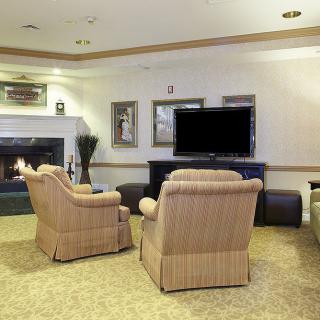 A cozy living room with comfortable seating and a large television.