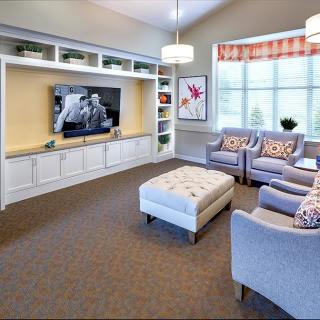 A cozy living room with comfortable seating and a large TV.