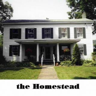 A historic homestead with a classic design and front yard.