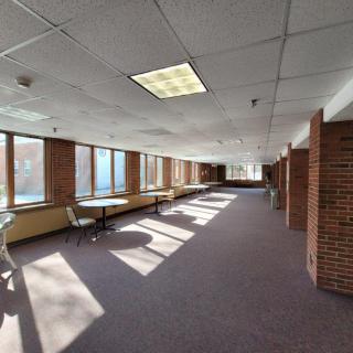 Spacious office interior with large windows and natural sunlight.