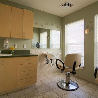 A well-lit hair salon interior with chairs and mirrors.