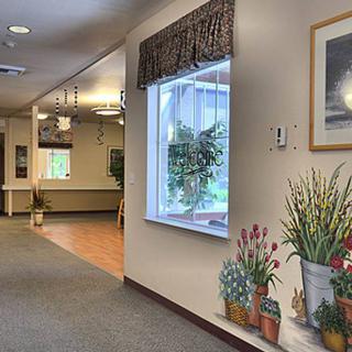 A well-decorated hallway with a window and potted plants.
