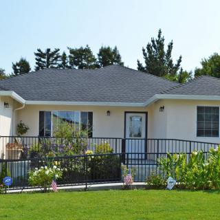 A single-story house with a well-maintained front yard and garden.