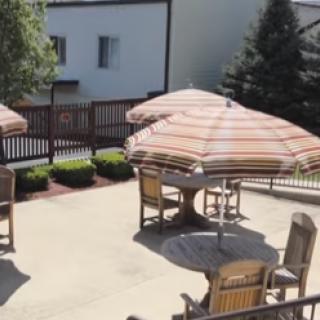 A serene outdoor patio area with shaded umbrellas, perfect for relaxation.