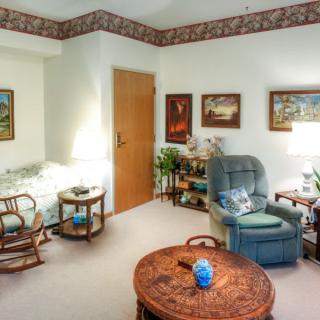 A cozy living room with comfortable seating and various decorative items.