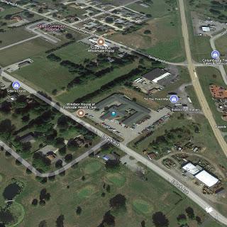 An aerial view of an urban area showing streets, buildings, and green spaces.