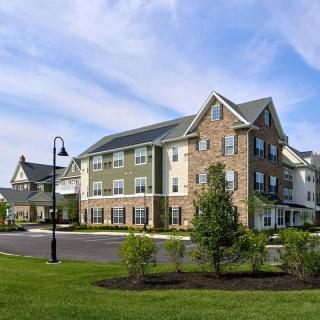 A modern residential apartment complex surrounded by greenery.