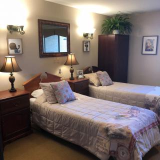 A cozy bedroom with twin beds and warm decor.