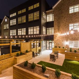 An inviting outdoor patio area with modern lighting and architecture at night.