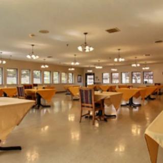 Spacious dining area with neatly arranged tables and chairs.