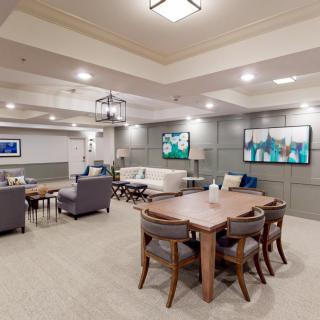 A modern living room with comfortable seating, stylish decor, and ample lighting.