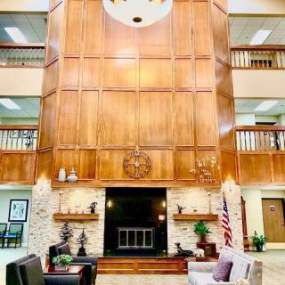 A spacious lobby with wood paneling and elegant furnishings.