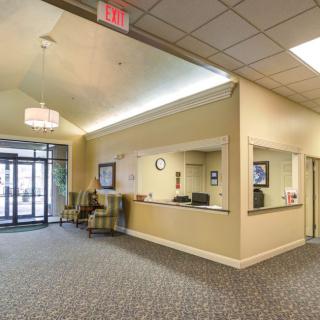 A spacious lobby with a reception desk and seating area near the entrance.