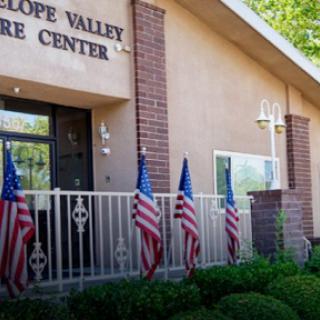 The Antelope Valley Community Center features a welcoming entrance adorned with American flags.