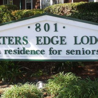 Sign for Waters Edge Lodge, a residence for seniors.