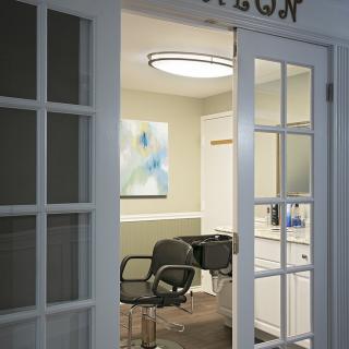 Interior view of a modern salon with stylish chairs and artwork.