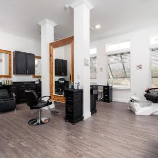 A modern salon interior with mirrors, chairs, and stylish decor.