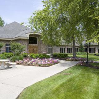 A well-maintained residential property with a landscaped garden and vibrant flowers.