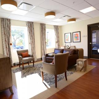 A cozy and well-lit living room with comfortable seating and elegant decor.