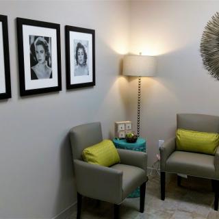 A cozy waiting room with modern decor and comfortable seating.