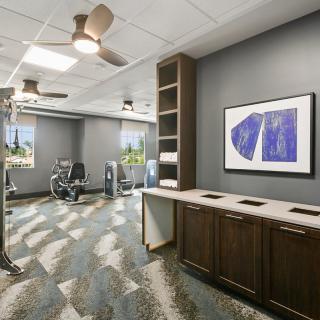 A well-lit gym with exercise equipment and modern decor.