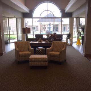A cozy lobby area with seating and large windows providing natural light.